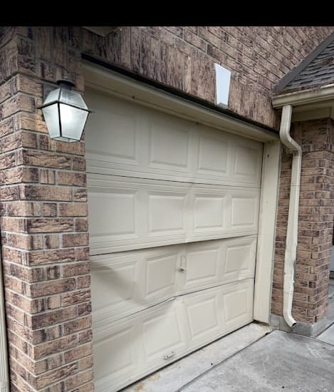 Damaged garage door before Garage Goat repair